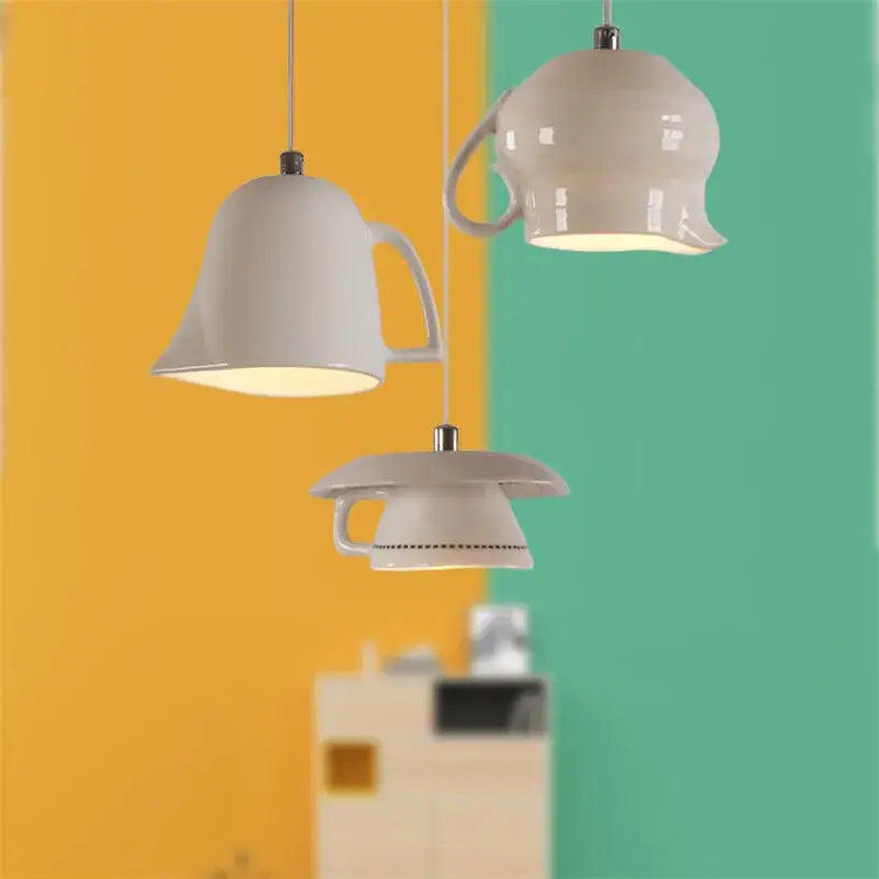 Three white ceramic led pendant lights hang against a vibrant yellow and teal wall for kitchen dining room decorbites ceramic led