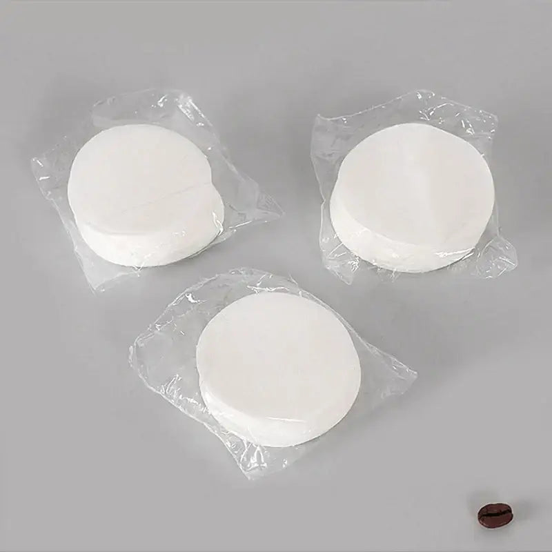 White circular disposable coffee filter papers individually wrapped in clear plastic for decorbites coffee filter use