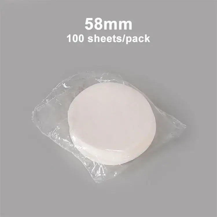 White circular disposable coffee filter papers 58mm in diameter packaged in clear plastic for espresso use decorbites coffee filter