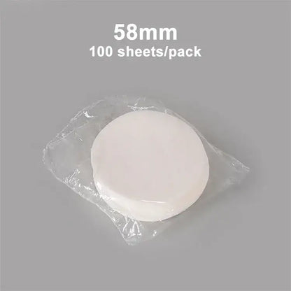 White circular disposable coffee filter papers 58mm in diameter packaged in clear plastic for espresso use decorbites coffee filter