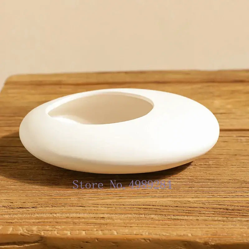 White ceramic soap dish with smooth rounded oval shape and recessed area for decorbites cobblestone deformation ceramic use