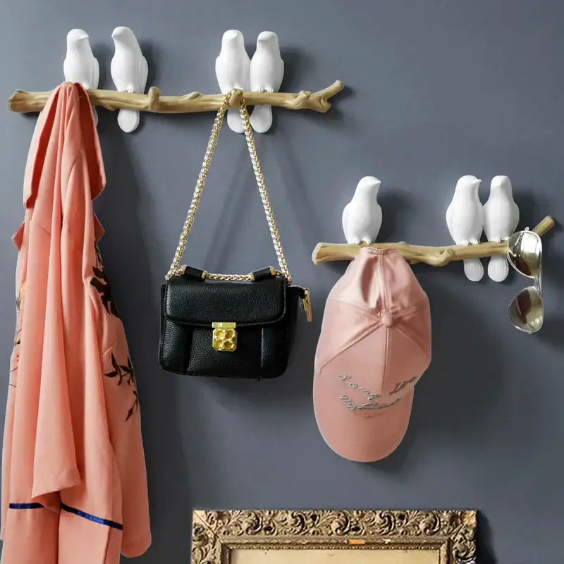 White decorbites bird resin hanger featuring ceramic bird-shaped hooks mounted on a rustic wooden branch