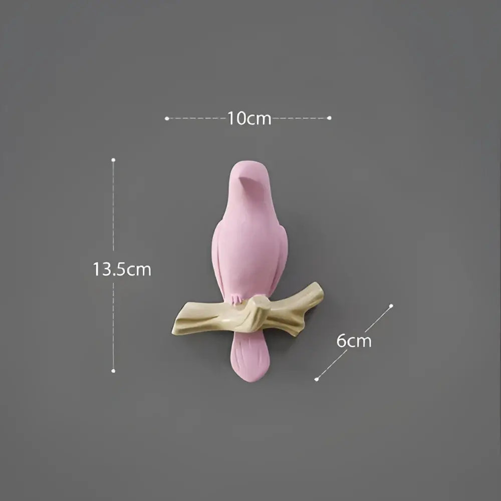 Pink ceramic decorbites bird resin hanger perched on beige wood branch for kitchen hook use