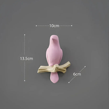 Pink ceramic decorbites bird resin hanger perched on beige wood branch for kitchen hook use