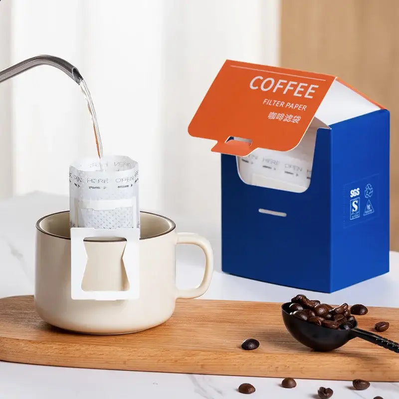 Beige ceramic mug with white disposable coffee filter bags from decorbites coffee filter pour over setup