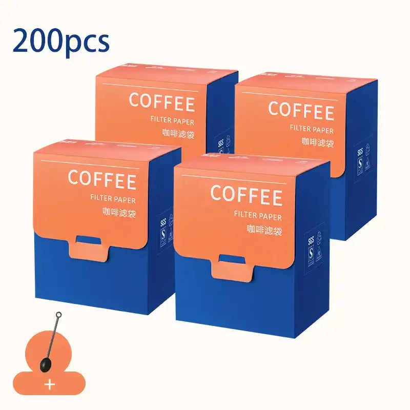 Four orange and blue decorbites coffee filter bags made of paper for white disposable kitchen pour over setup