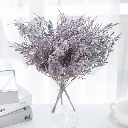 A delicate white dried baby’s breath lavender bouquet displayed in a clear glass paper box vase for living room decor