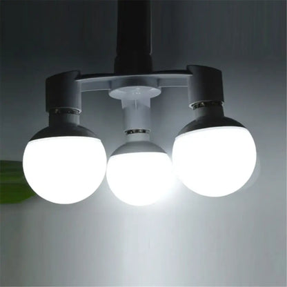Three spherical led light bulbs with frosted glass shades and black fixtures on a white e27 lamp 3-way converter pack