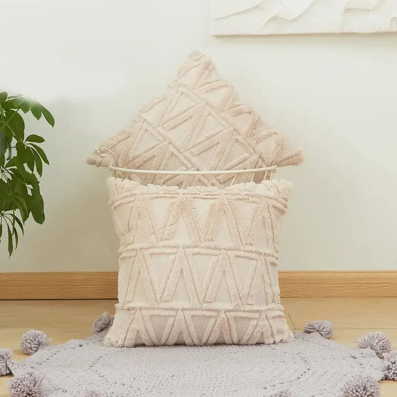 Cream-colored embroidered diamond cushion cover with geometric triangle patterns and fringed edges for living room decor