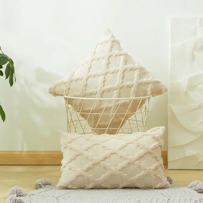Cream-colored textured cushion cover with embroidered diamond knit design and soft fringe edges for living room decor