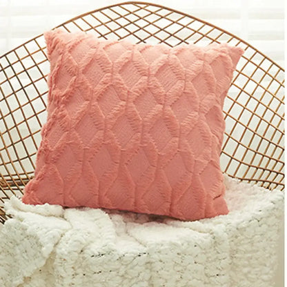 A soft blush pink embroidered diamond cushion cover with plush fabric and textured pattern for living room decor