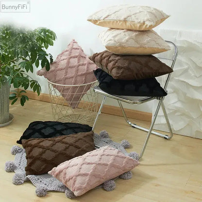 Stack of plush embroidered diamond cushion covers in soft pink beige brown and black for living room decor