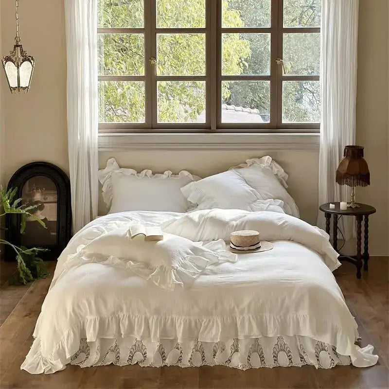 White embroidered lace cotton ruffles bedding set with delicate lace trim and soft flowing fabric for luxury bedroom use