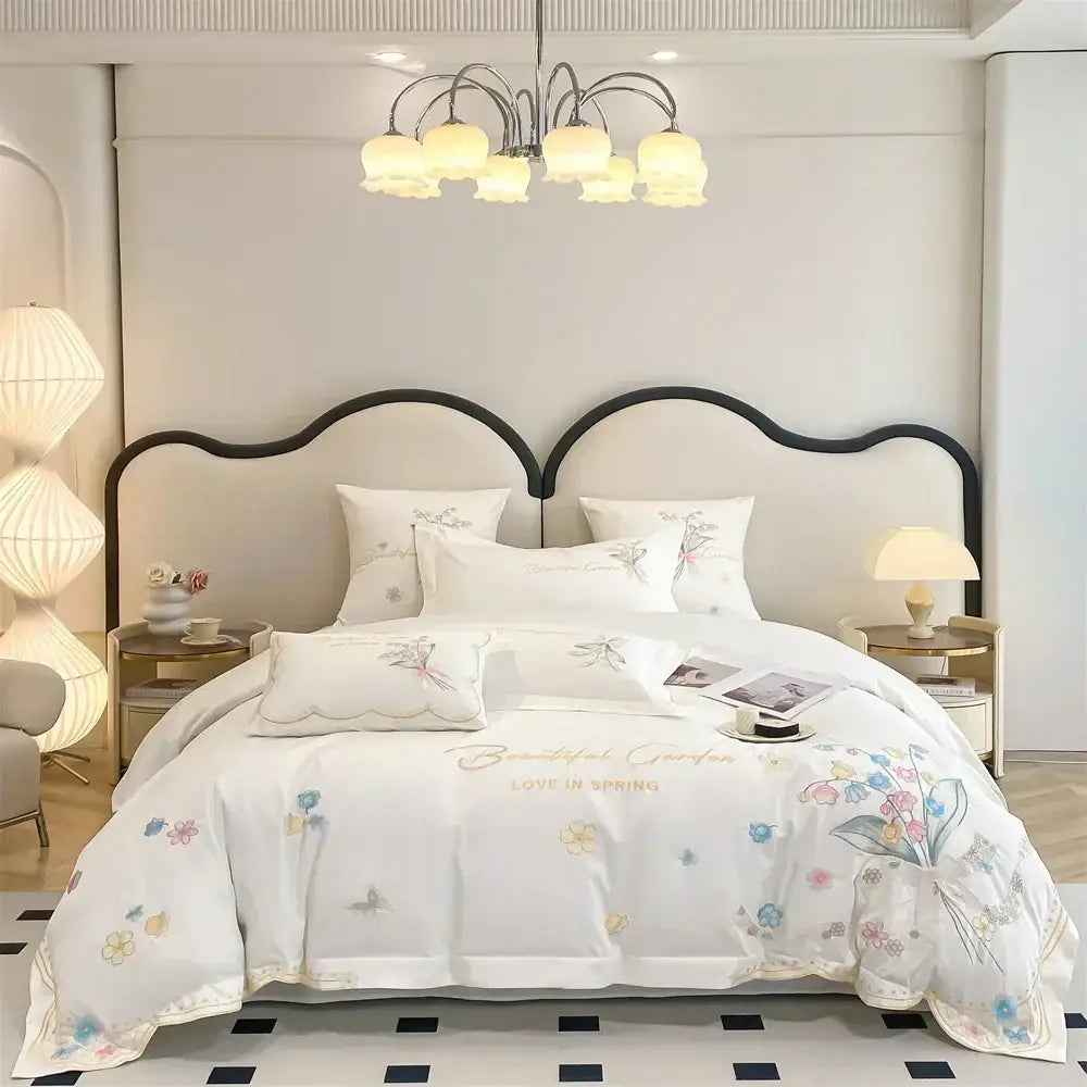 White floral bedding set with delicate pastel decorbites butterfly flowers embroidery and gold lettering detail