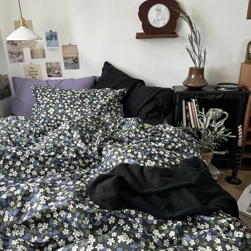 Dark green cotton duvet cover set with white and purple floral embroidery featuring soft fabric draping naturally