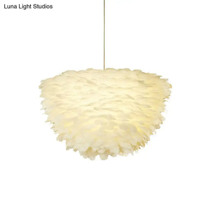 White floral pendant chandelier with cream-colored soft feather accents hanging from a thin cord for dining room
