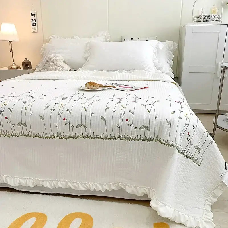 White quilt set with fresh flower embroidered delicate floral patterns in gray red and green featuring ruffled edge cotton bedding