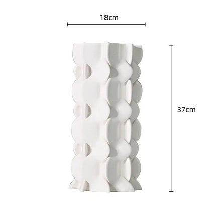 A tall white ceramic vase with a distinctive geometric ceramic fold pattern for living room decorbites decor
