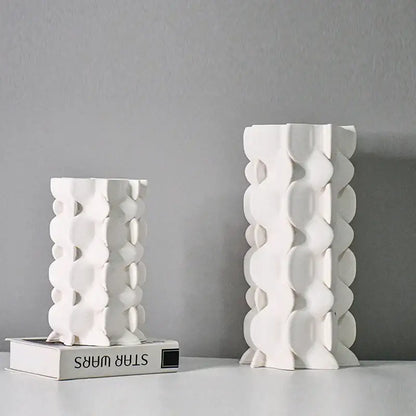 Two white geometric ceramic fold pattern vases with sculptural circular cutouts for living room decorbites decor