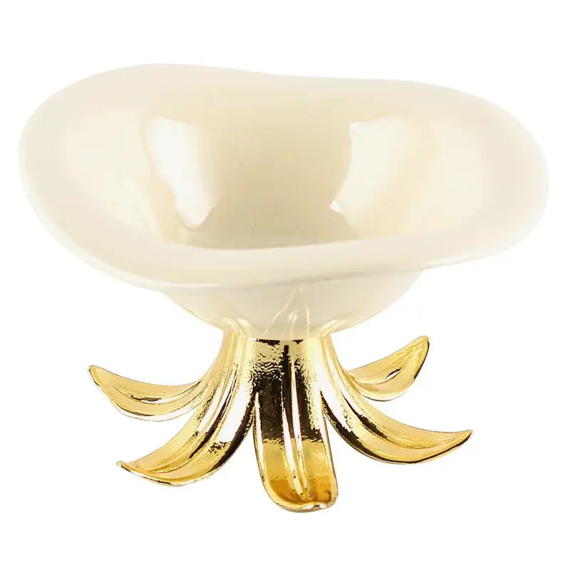 Cream-colored ceramic fruit plate with a glossy finish on an ornate gold-toned metal petal base tray bowl centerpiece