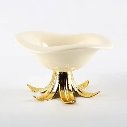 Cream-colored ceramic fruit plate with gold-toned leaf pedestal base for elegant dining room centerpiece tray bowl