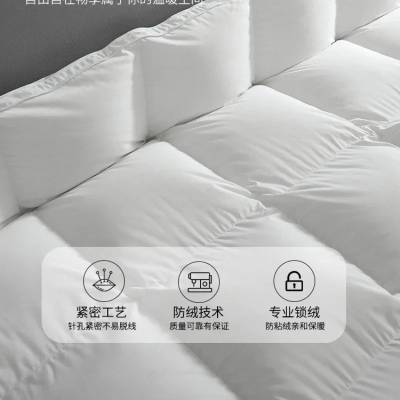 White quilted goose down comforter with plush soft texture and clean stitching for autumn winter use