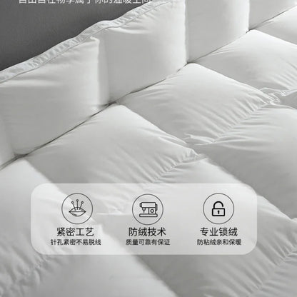 White quilted goose down comforter with plush soft texture and clean stitching for autumn winter use