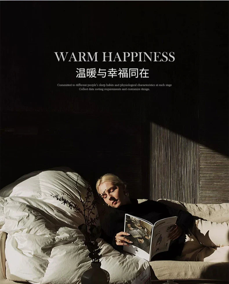 A woman with blonde hair reclines on a bed wrapped in a thick white goose down autumn winter velvet duvet