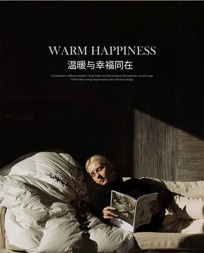 A woman with blonde hair reclines on a bed wrapped in a thick white goose down autumn winter velvet duvet