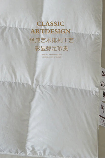 White quilted goose down comforter with classic art design and gold text branding for autumn winter use