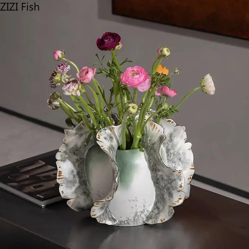 White and gray ruffled ceramic vase with gold trim holding artificial flowers for decorbites colorful wings living room decor