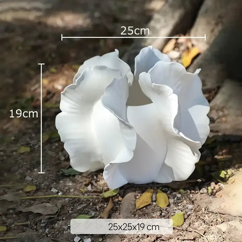 White and gray ruffled ceramic vase with artificial flowers and white ceramic flower sculpture for decorbites colorful wings decor