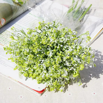 A delicate bouquet of white gypsophila artificial flowers with realistic green and white petals for wedding decor