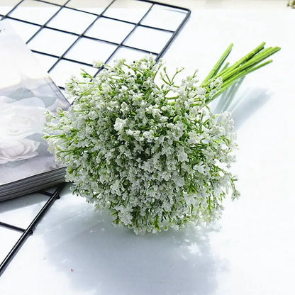 A delicate bouquet of white gypsophila artificial flowers with tiny blossoms and slender green stems for decor