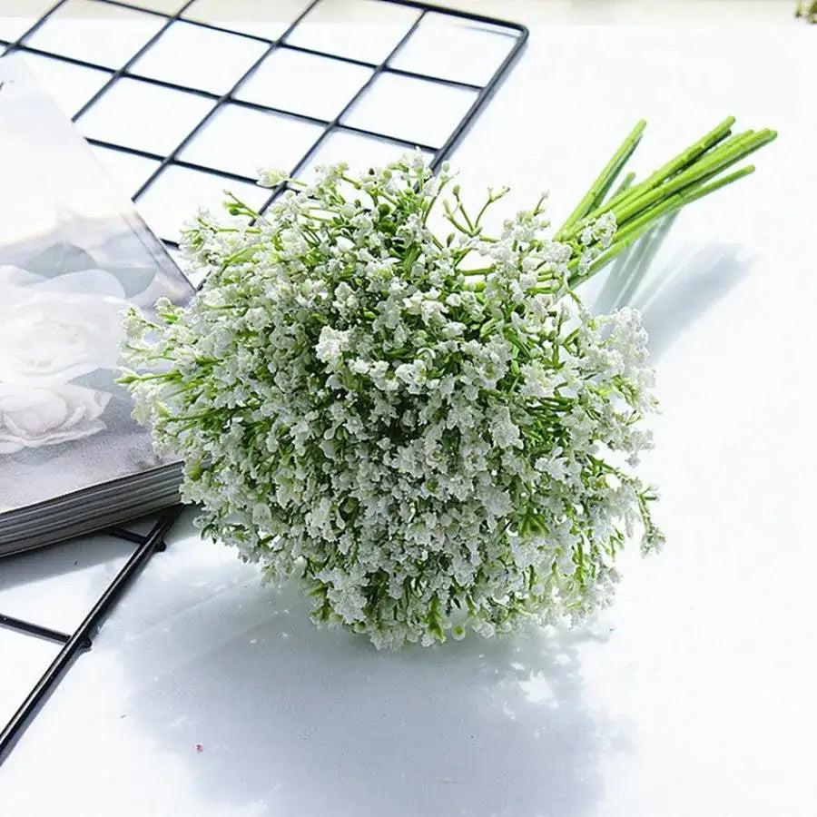 A delicate bouquet of white gypsophila artificial flowers with tiny blossoms and slender green stems for decor