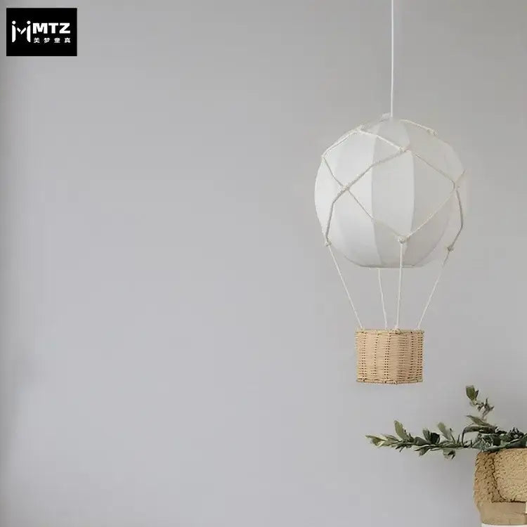 White hot air balloon chandelier with woven wicker basket and macrame detailing for kids room decorbites hot air