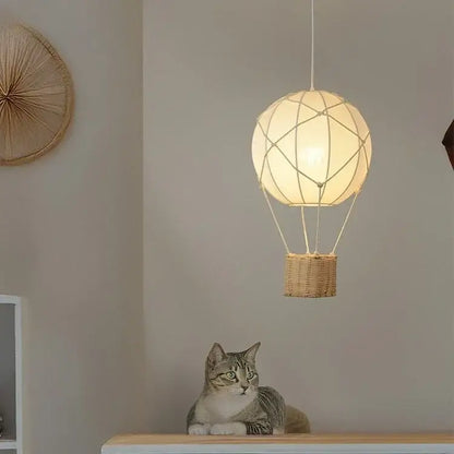 White hot air balloon chandelier with woven wicker basket and macrame string detailing for kids room decorbites hot air