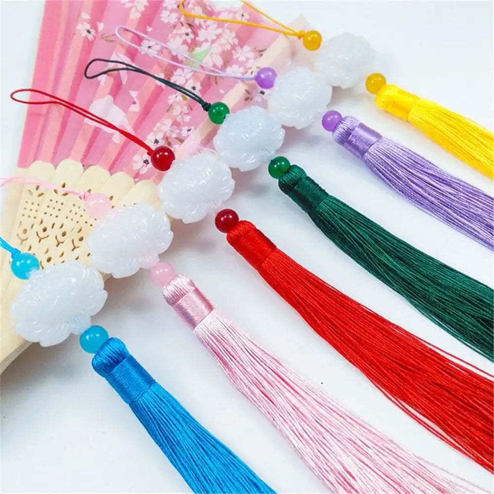 White jade lotus cloud-shaped charms with colorful silk tassels and beaded tops for living room decor