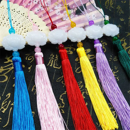 A set of white jade lotus tassel decorative pendants with carved jade lotus tops and colorful silk tassels for living room decor