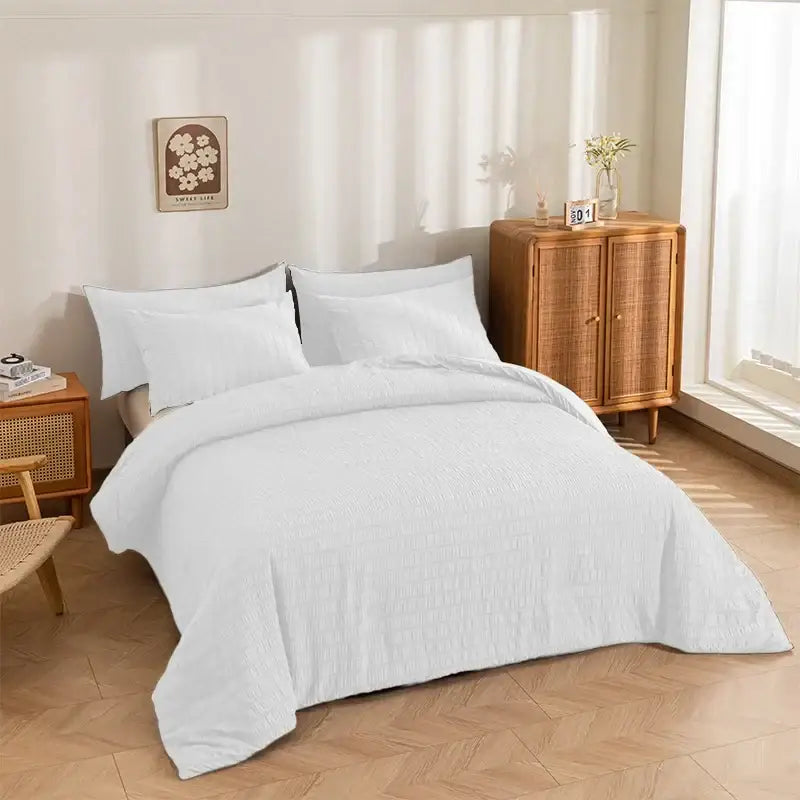White king size seersucker quilt with textured ribbed pattern draped over bed in bright minimalist bedroom decorbites king size