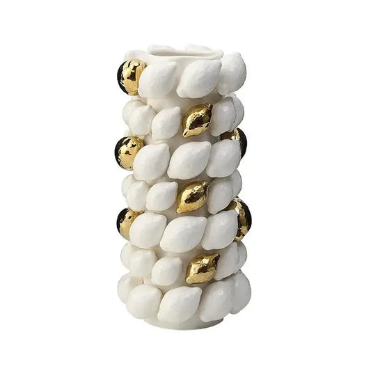 White ceramic vase with textured shell-like protrusions and gold black spheres in lemon carambola design for living room decor