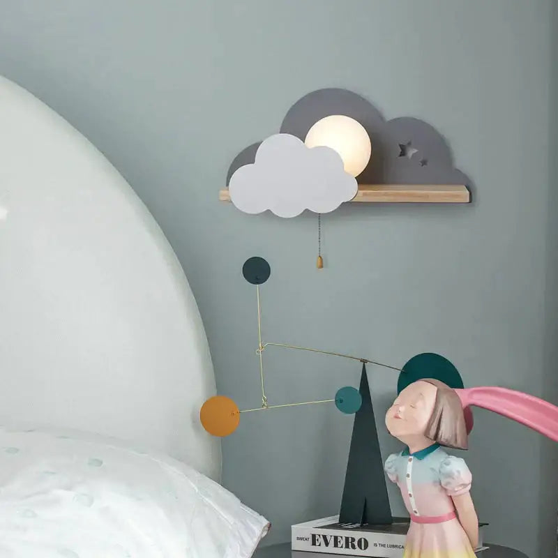 White macaron led cloud wall lamp with warm glow and layered gray and white cutout clouds on wooden shelf for children bedroom