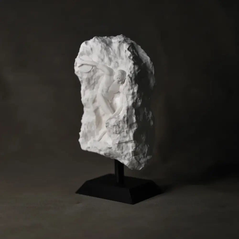White marble discus throwing nude sculpture in stone relief mounted on black pedestal for home decor