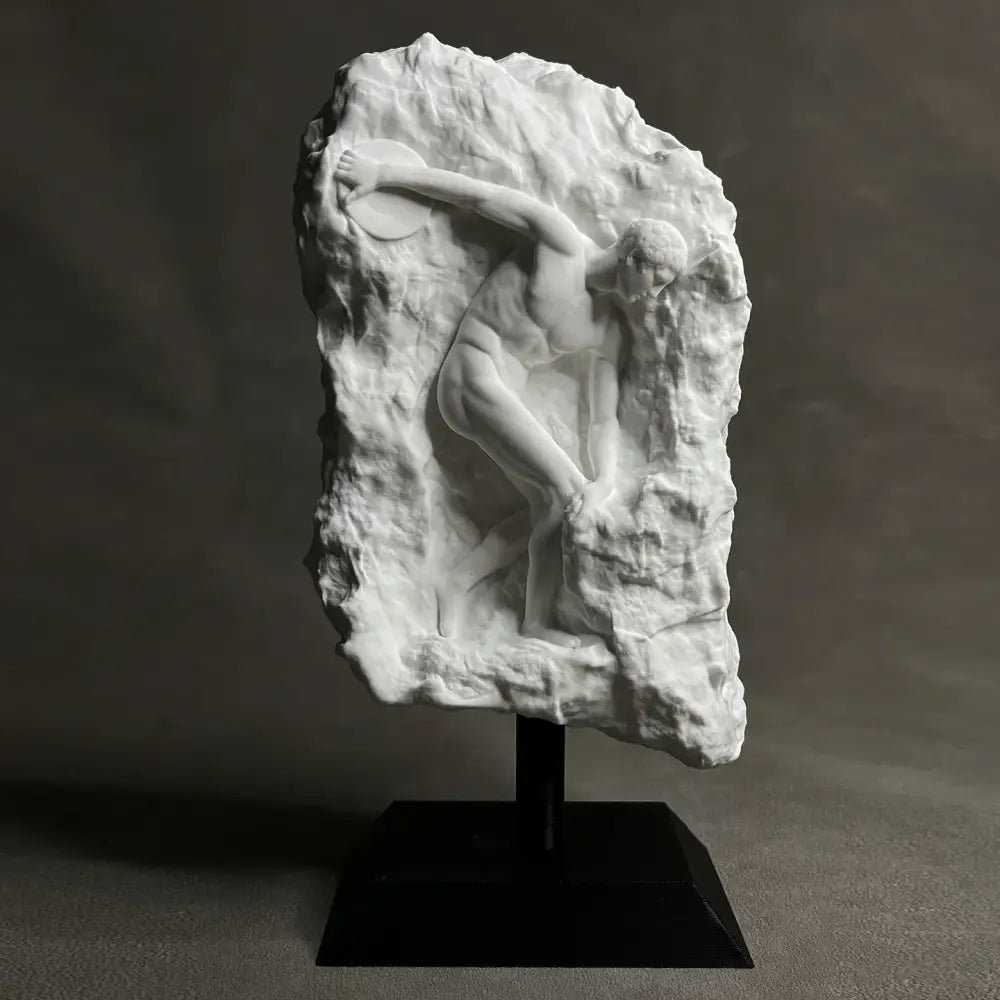 White marble discus throwing nude sculpture in dynamic pose carved into rugged rock for home decor in living room