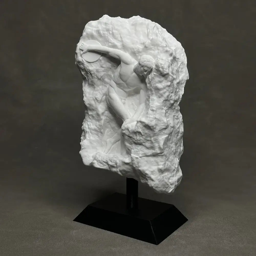 White marble discus throwing nude sculpture climbing rock mounted on black pedestal for elegant home decor