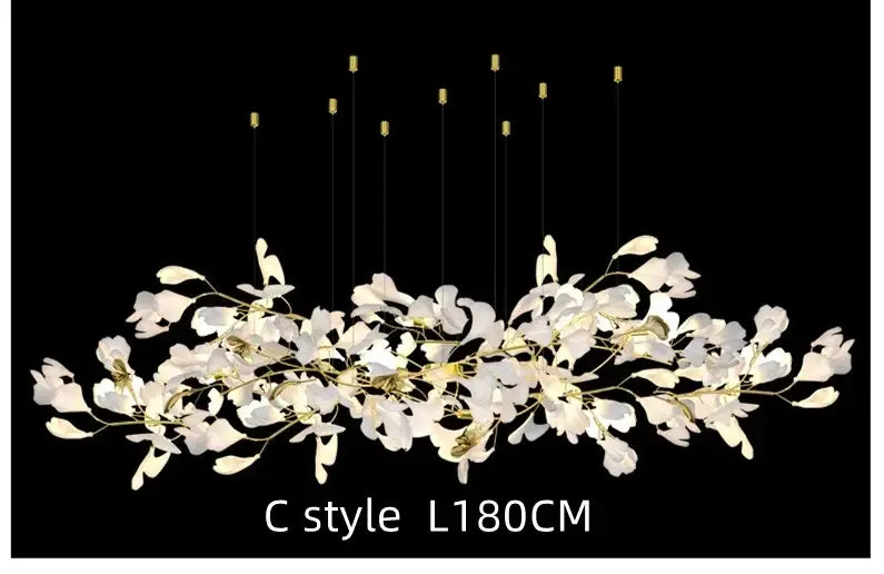 White orchid decorbites ginkgo chandelier with gold-toned accents and slender wires in a c-style living room pendant light