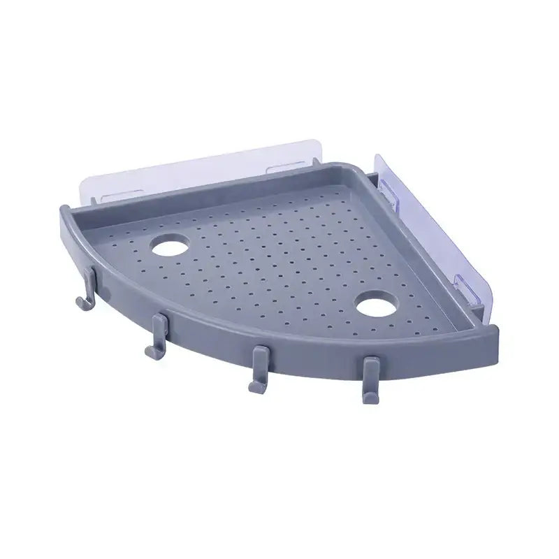 Gray plastic corner bathroom shelf organizer caddy with perforated surface, circular cutouts, and four hooks