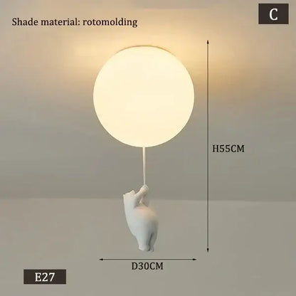 White rotomolded polar bear ceramic pendant light for kids bedroom holding a softly glowing round cord pendant light shade