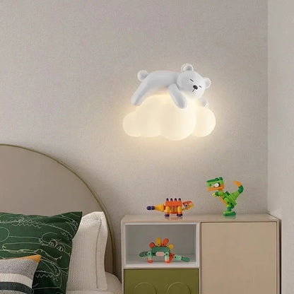 White polar bear led wall lamp resting on a cloud base emitting warm light ideal for childrens bedroom use