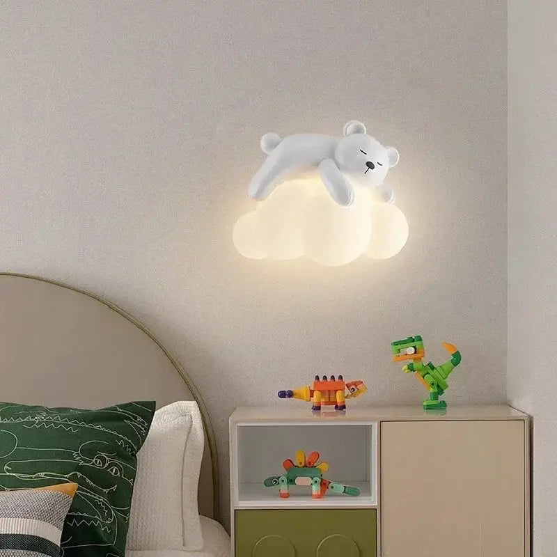 White polar bear led wall lamp resting on a cloud base emitting warm light ideal for childrens bedroom use